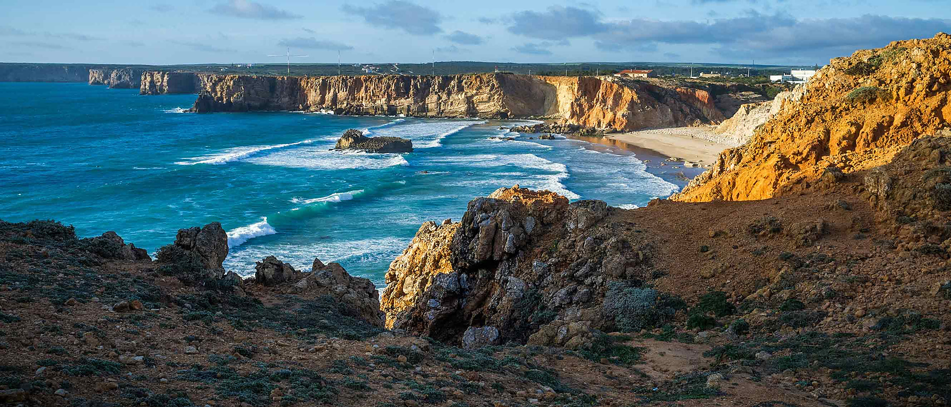 Scenic coastal cliffs overlooking the ocean and beach. Aldeia da Pedralva