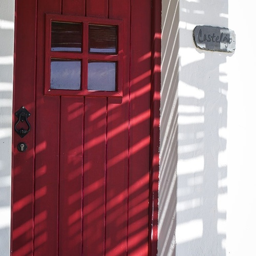 a red door with a sign that says castela on it