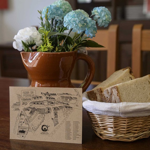 Welcome to Aldeia da Pedralva: bread basket and flowers on a wooden table.