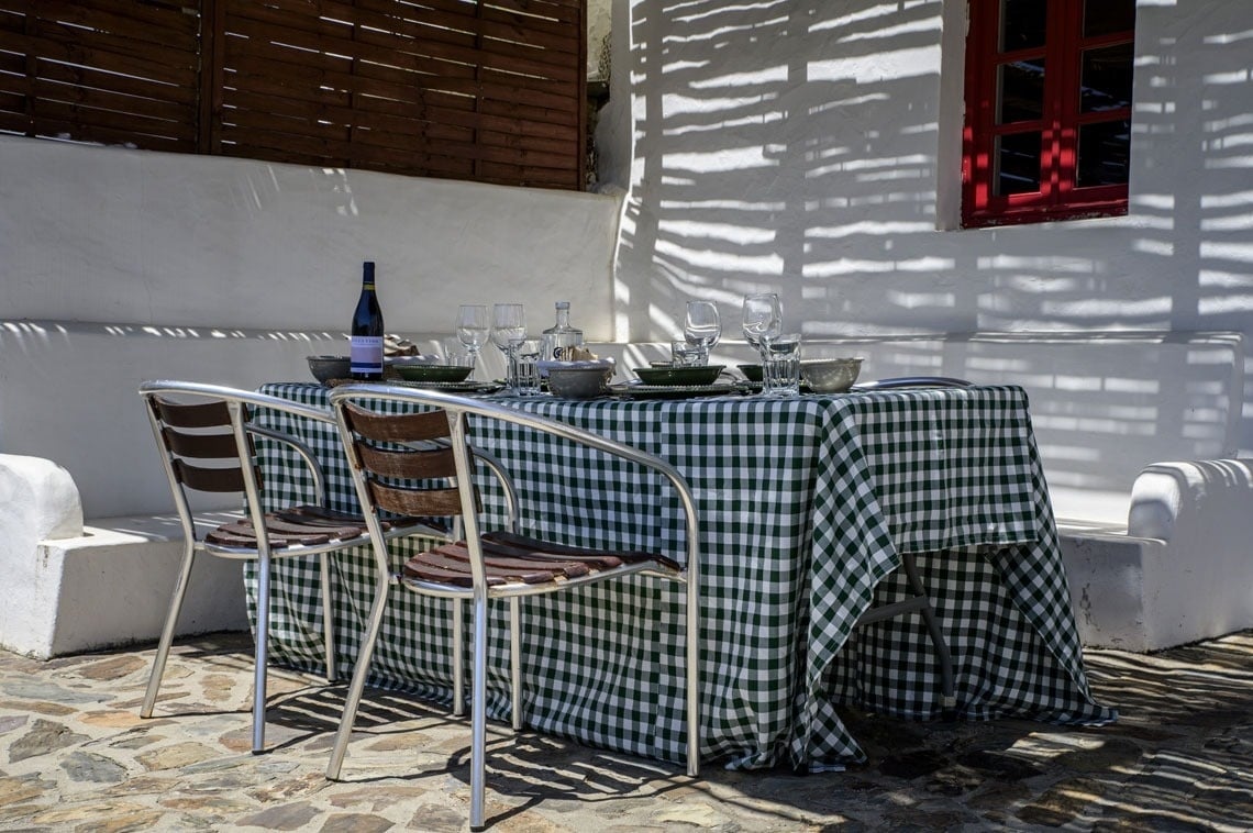 a white house with a red door and a sign that says cottage