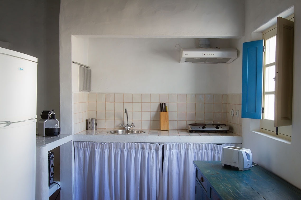 una cocina pequeña con una nevera blanca y una tostadora