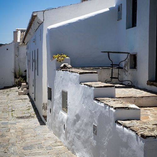a white building with a table on the side of it