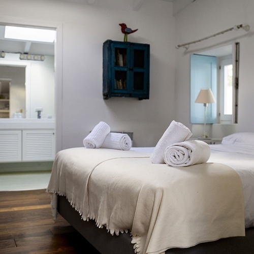 a bedroom with a blue cabinet on the wall above the bed