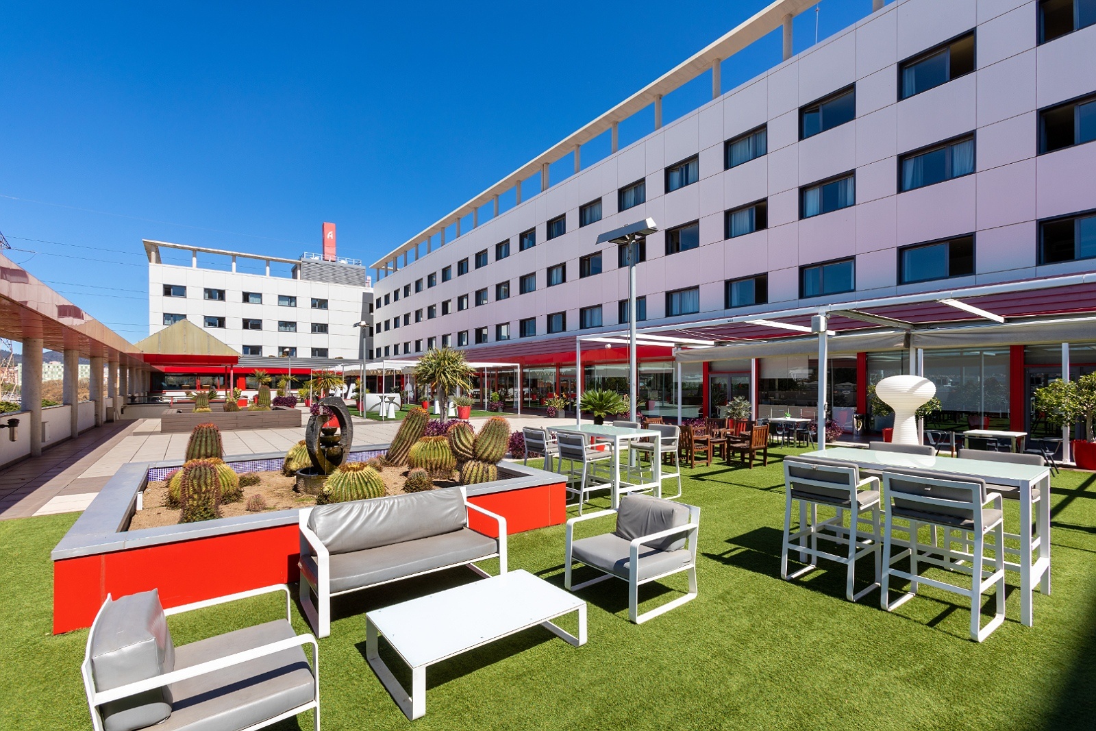 Terraza Alexandre FrontAir Congress: Hotel 4 estrellas con mobiliario exterior y cactus.