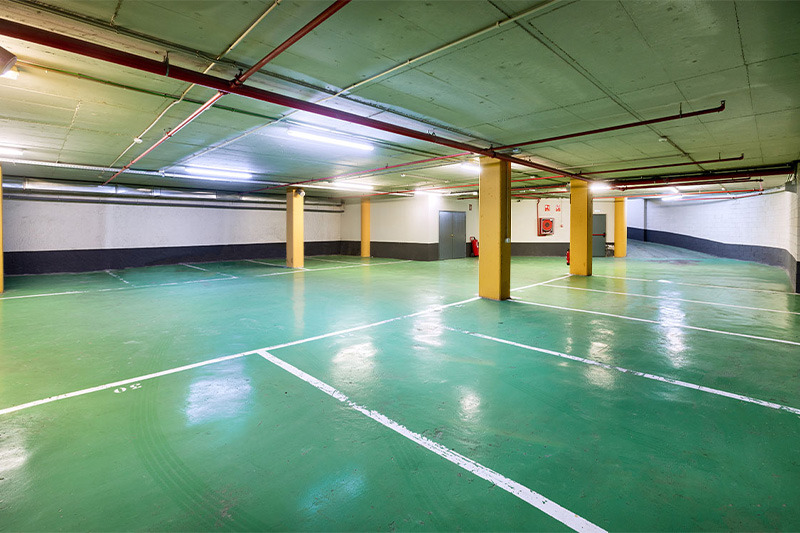 Alexandre Corporativa parking: spacious, well-lit, and clean underground garage with marked spots.