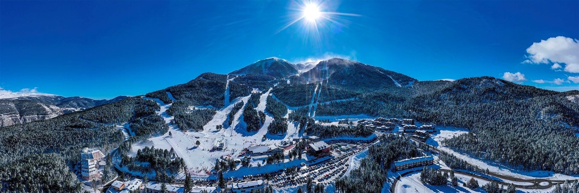 an aerial view of a ski resort in the mountains