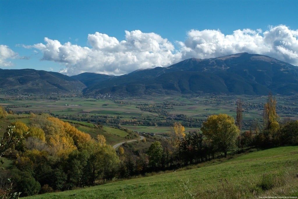 a view of a valley with mountains in the background