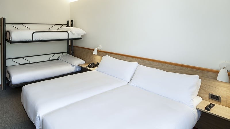 HABITACIÓN MÚLTIPLE - una habitación de hotel con dos camas y una litera