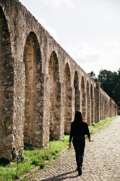 Edifício moderno e aqueduto histórico em AndTales Suites, Portugal.