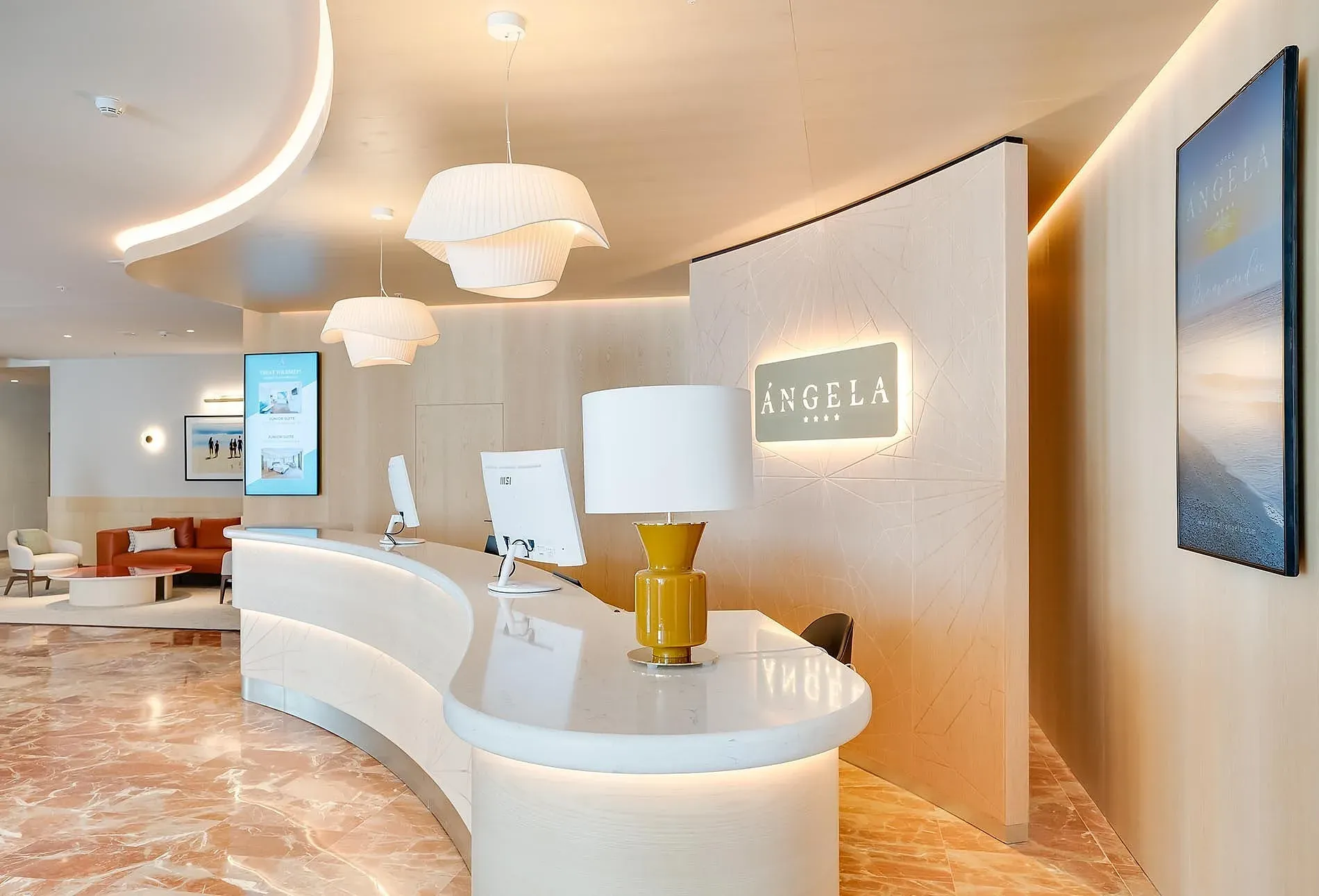 Réception moderne de l'Hôtel Angela avec sol en marbre et design élégant.