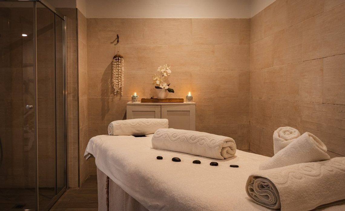 a massage table with towels and candles on it