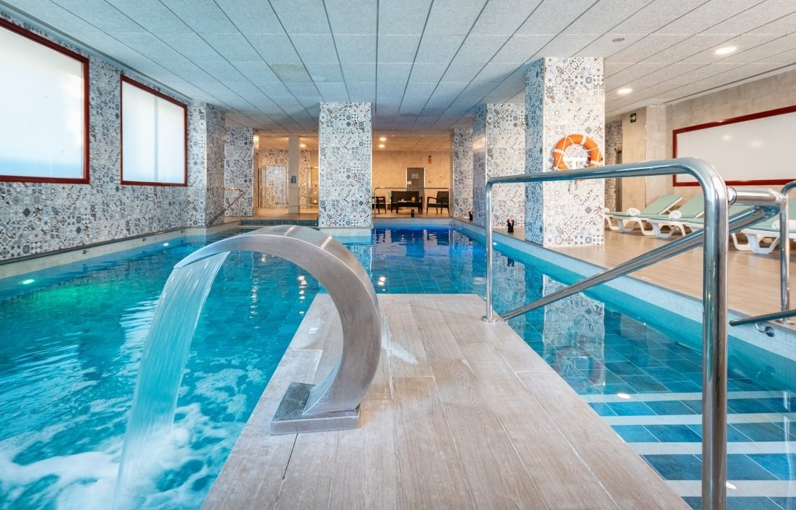 a swimming pool with a life preserver on the wall