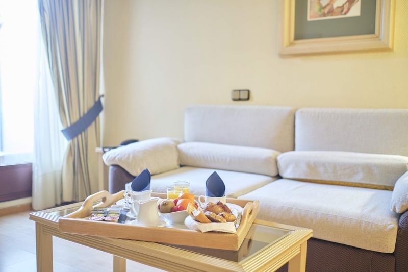 a tray of food sits on a table in front of a couch