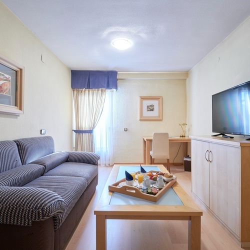 a living room with a couch and a flat screen tv