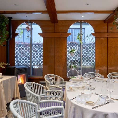 a dining room with tables and chairs and a fireplace