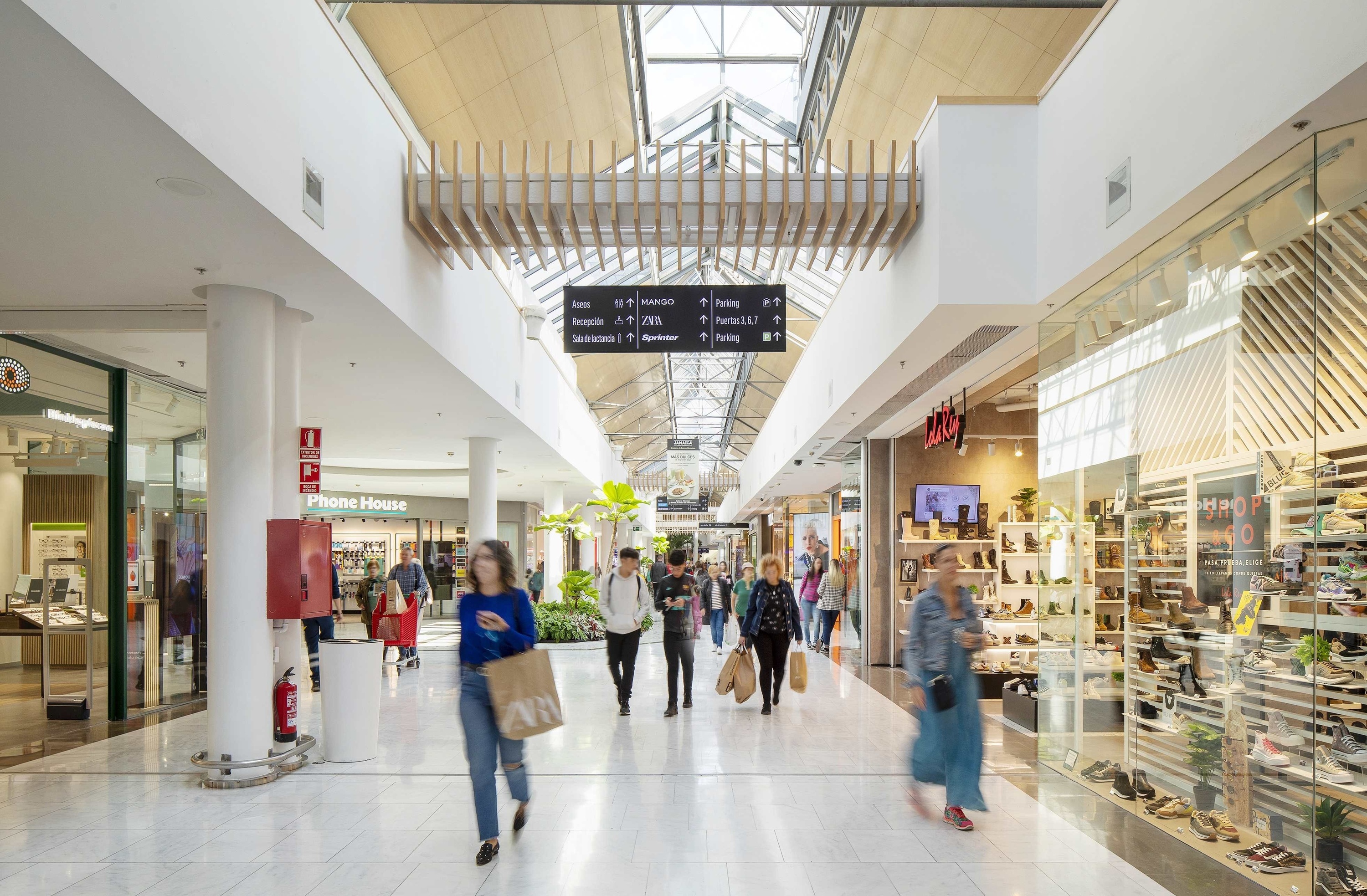 a shopping mall with a fire extinguisher in the middle