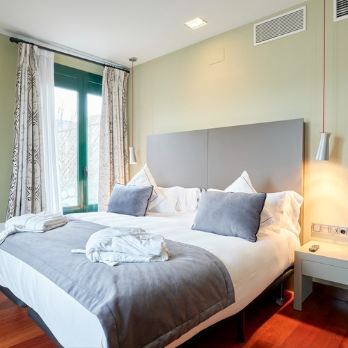 a hotel room with a large bed and a window