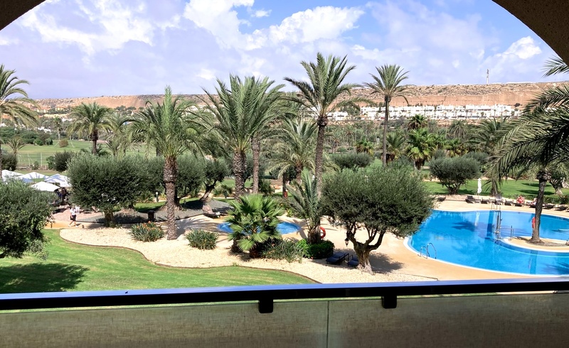 a large building with a pool in front of it