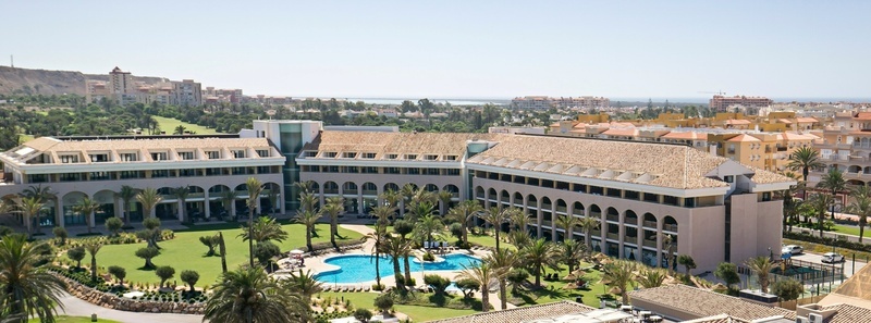 a large building with a pool in front of it