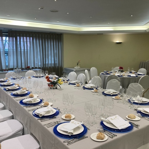 a long table with plates and glasses on it