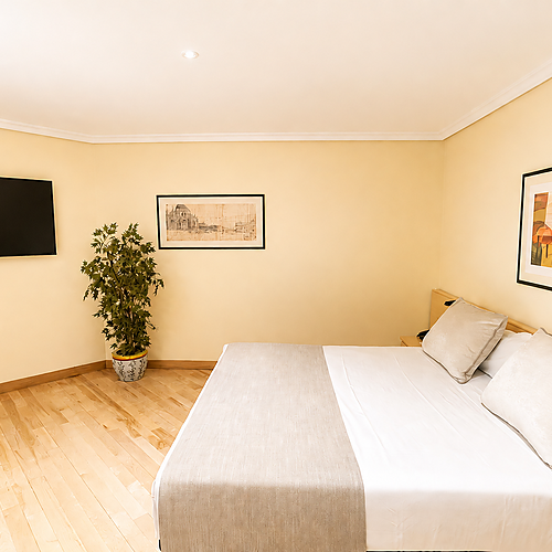 Comfortable hotel room with breakfast in bed, perfect for your stay near AR: Parquesur.