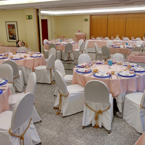 a room with tables and chairs set up for a wedding reception