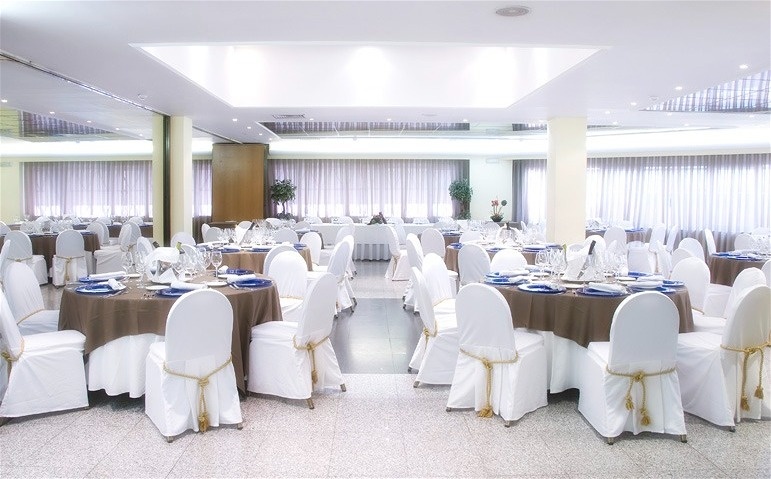 a large room with tables and chairs set up for a wedding reception