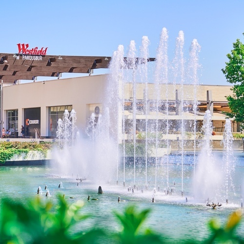 a fountain in front of a building that says westfield