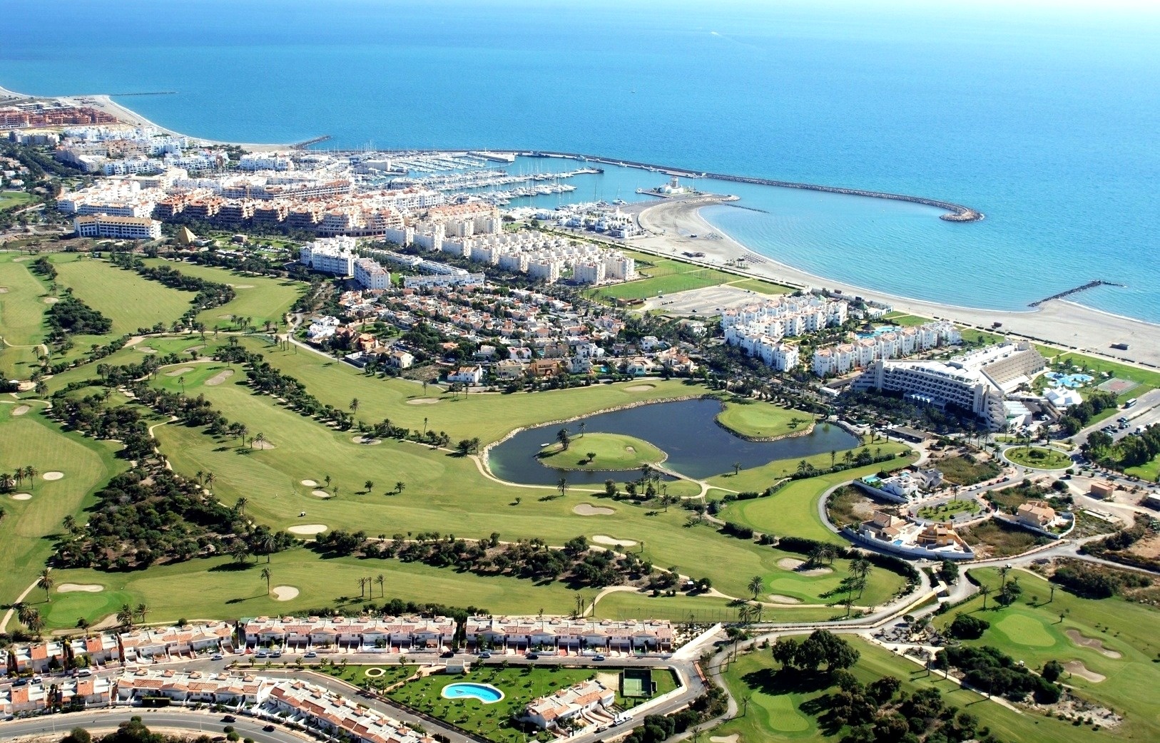 an aerial view of a golf course near the ocean