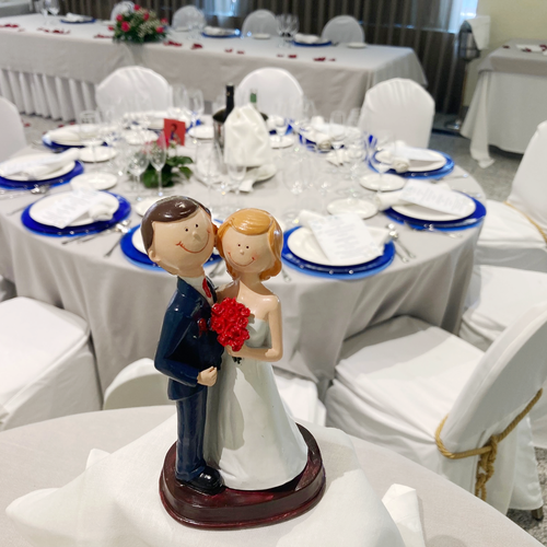 a figurine of a bride and groom sitting on top of a table