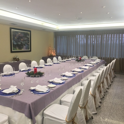 a long table with plates and glasses on it