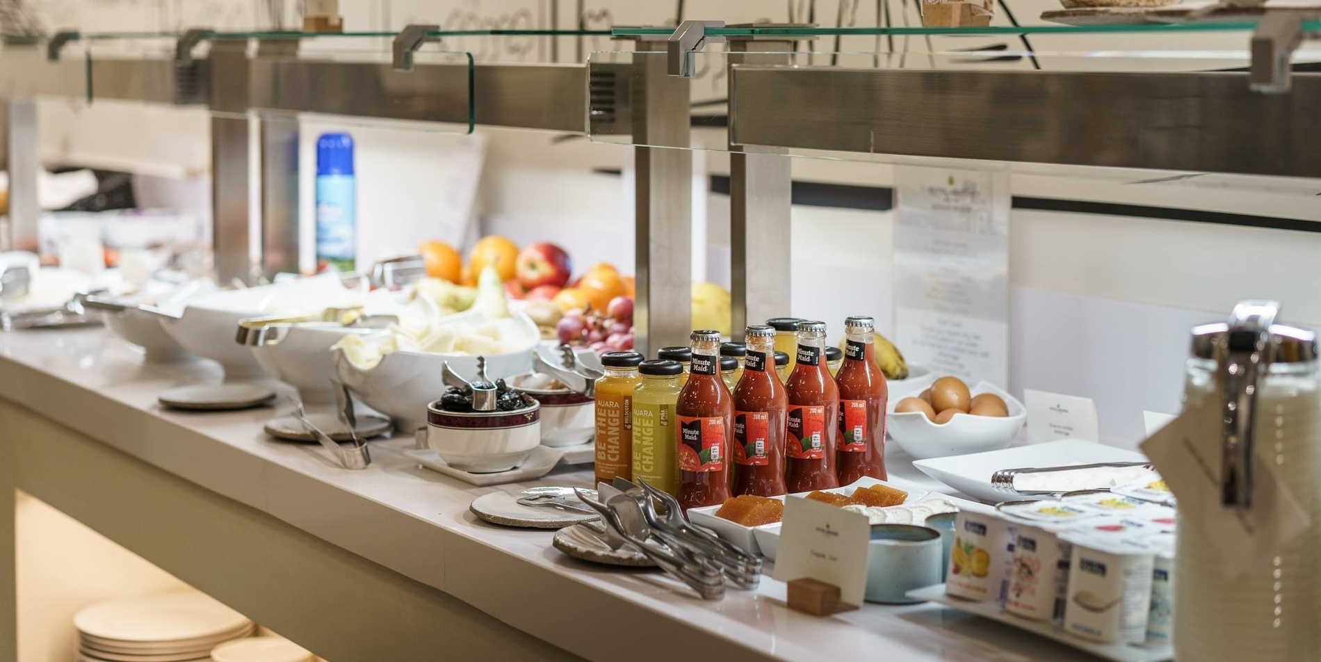 bottles of orange juice sit on a buffet table