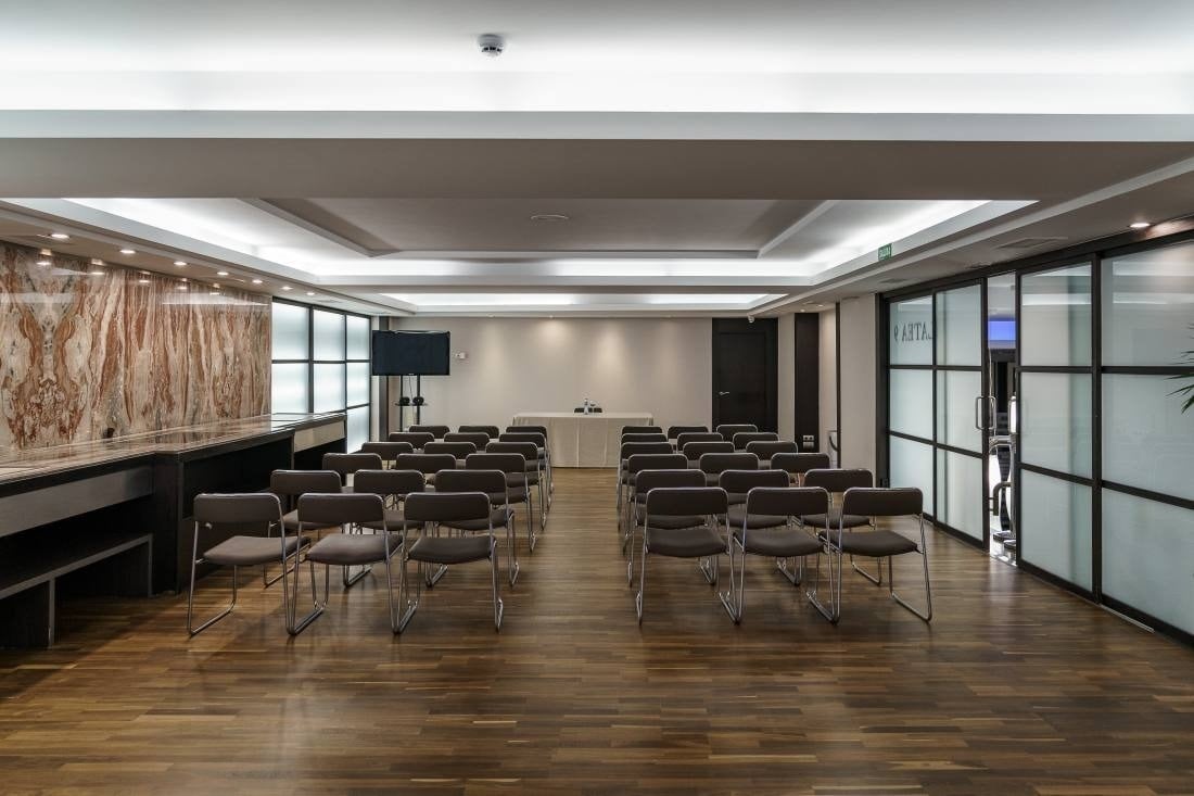 a conference room with rows of chairs and a table