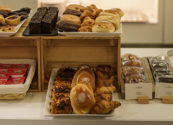 a variety of pastries are displayed on a table next to a box of nutella