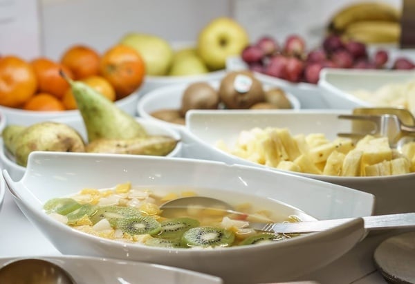 a bowl of fruit with a spoon in it