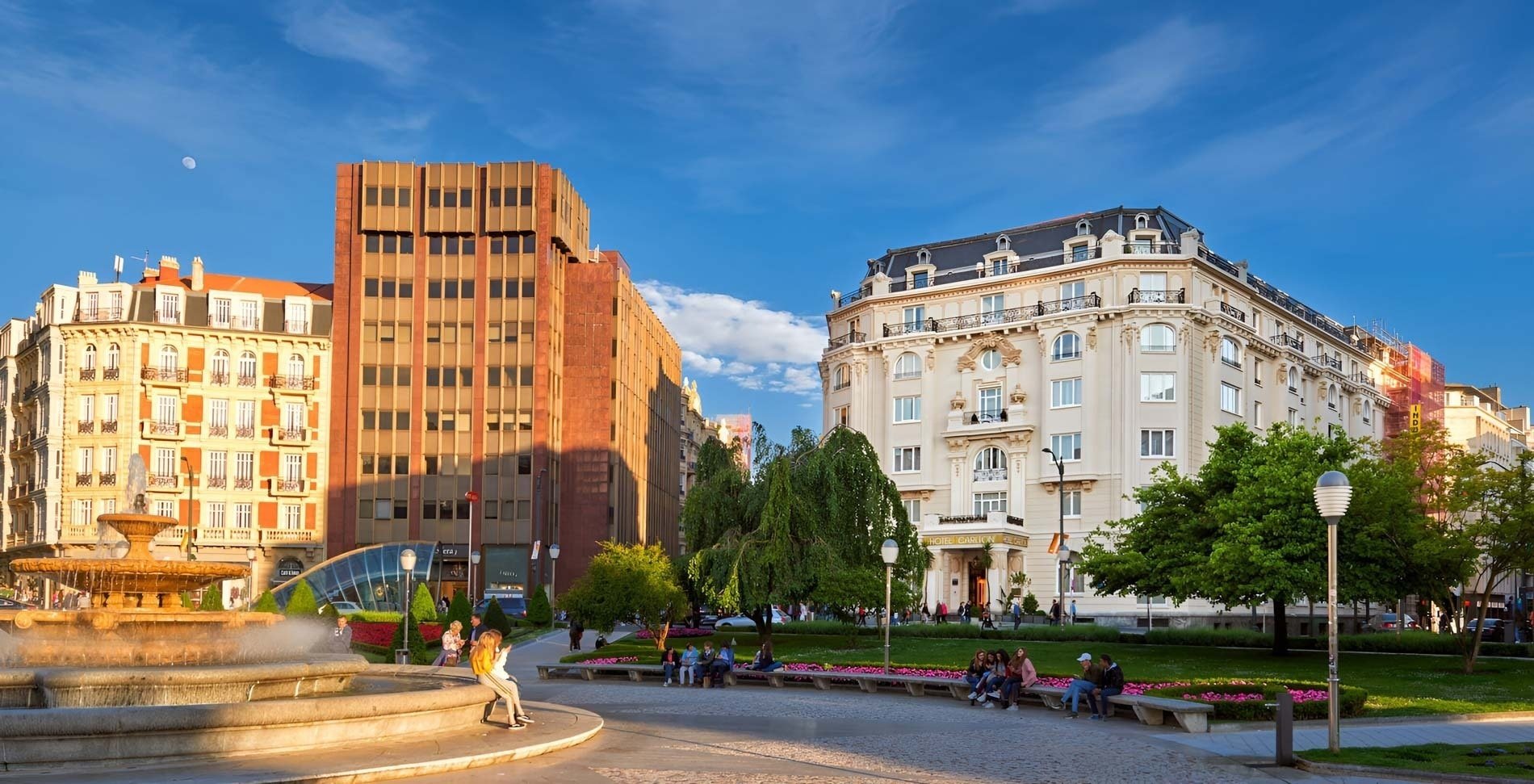 a hotel called hotel carlo sits on the corner of a city street