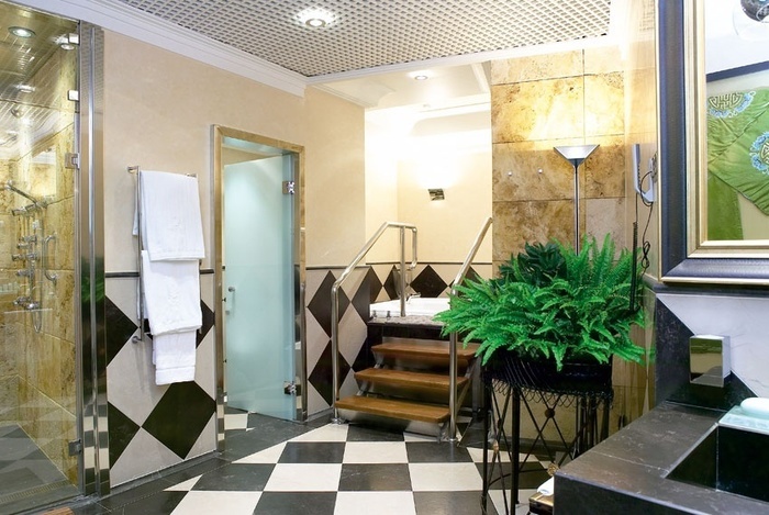 a bathroom with stairs leading up to a jacuzzi tub