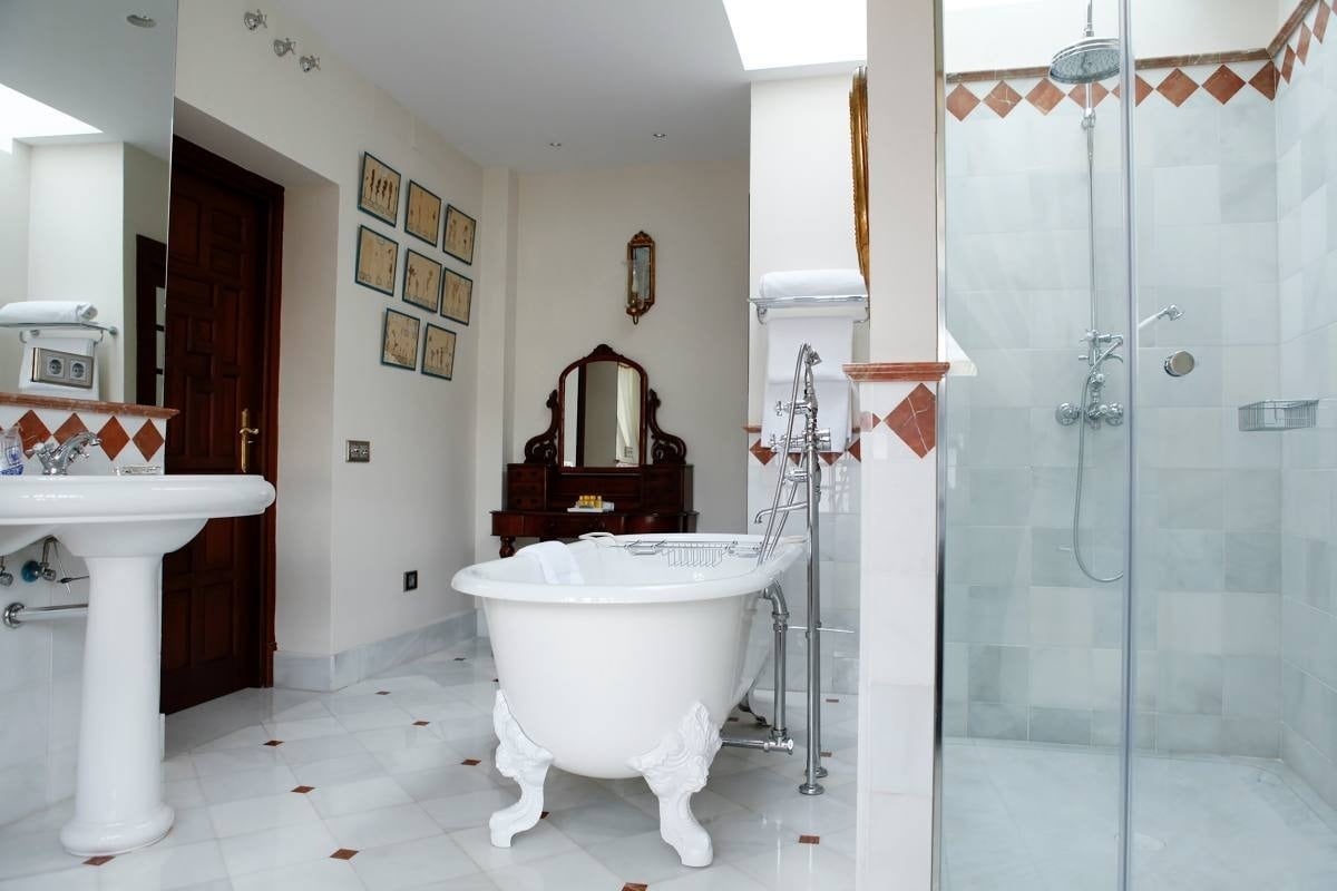 a bathroom with a claw foot tub and a walk in shower