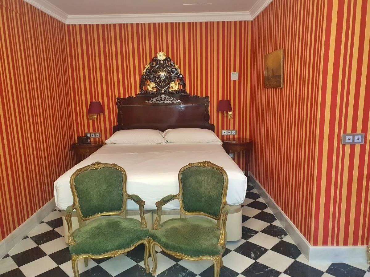 a bedroom with red and yellow stripes on the walls