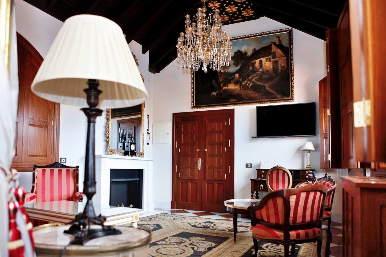 a living room with a painting on the wall above the fireplace