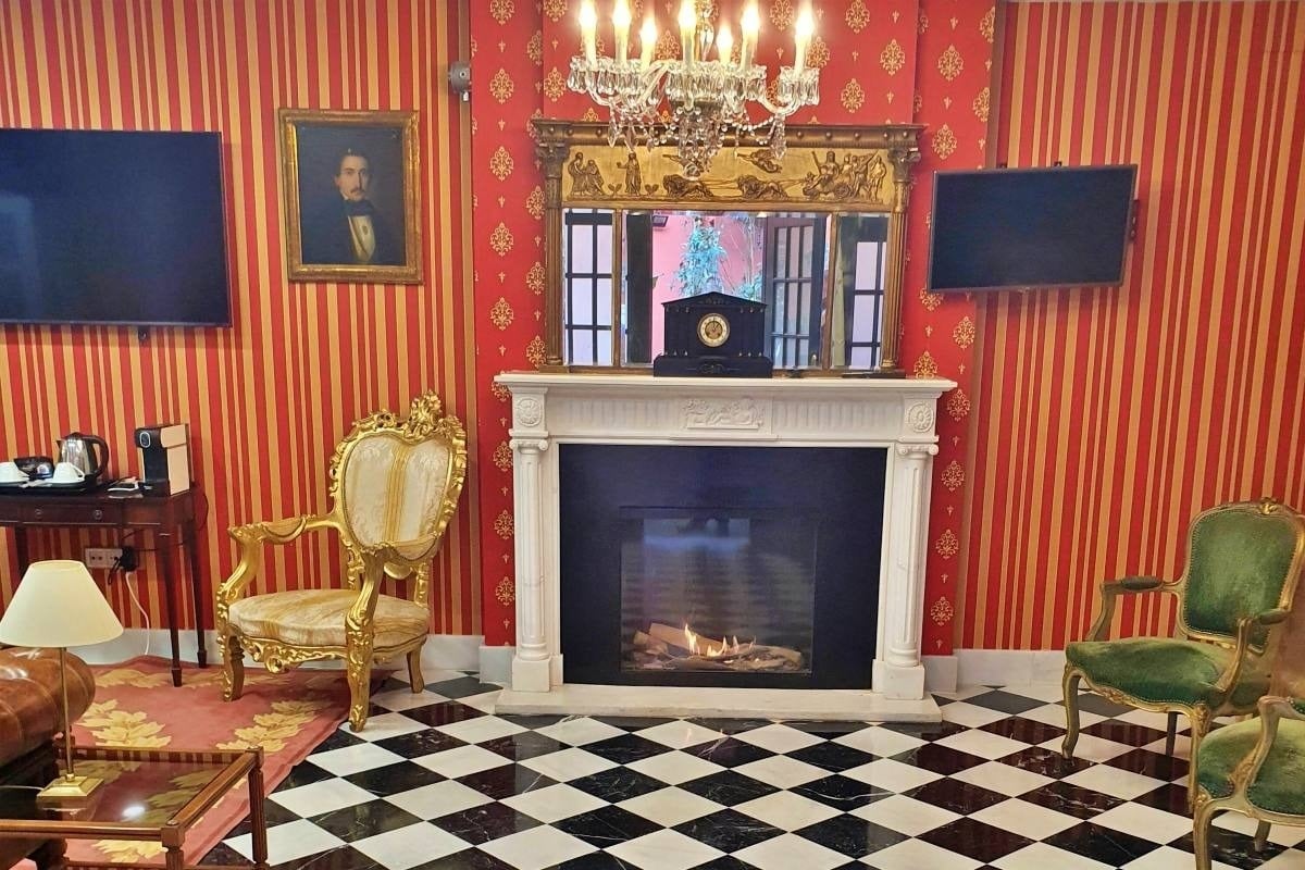 a living room with a fireplace and a clock on the mantle