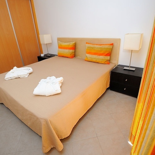 a bedroom with a large bed and two nightstands