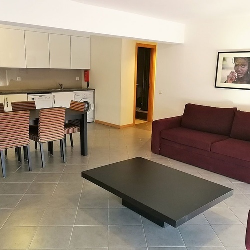 a living room with a red couch and a black coffee table