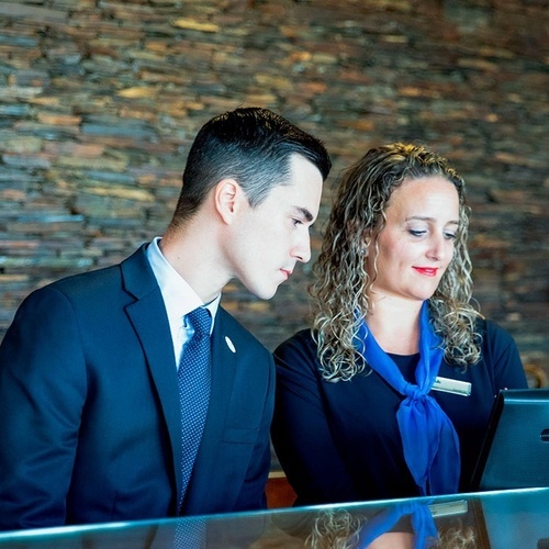 a man and a woman are looking at a computer screen