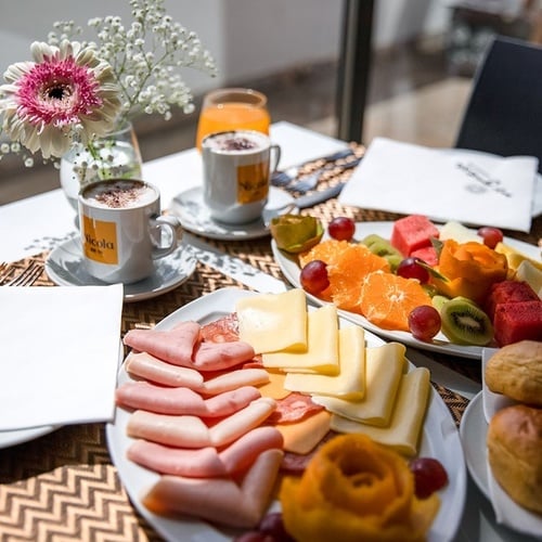 a table with plates of food and a napkin that says my guest