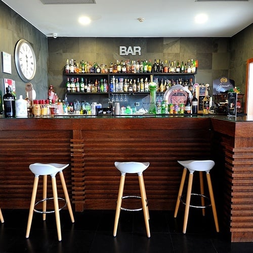 the word bar is on the wall above the bar