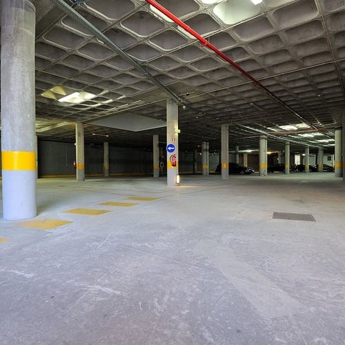 an empty parking garage with a no entry sign