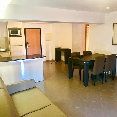 a living room with a dining table and chairs