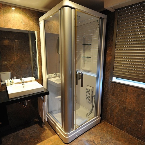 a bathroom with a walk in shower and a sink