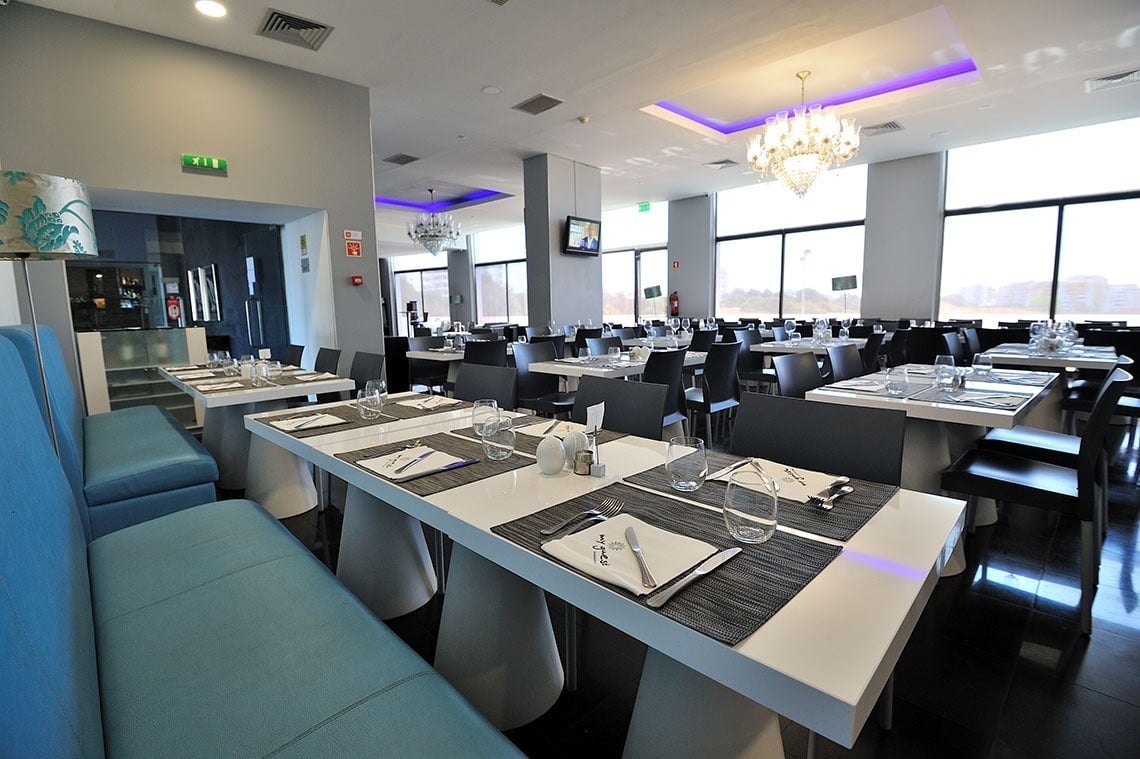 a restaurant with many tables and chairs and a sign that says fire exit